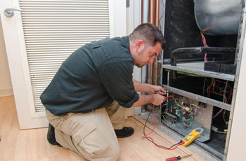 HVAC contractor performing a furnace repair