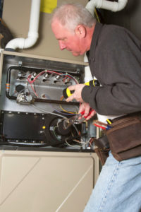 image of a furnace inspection by a furnace technician