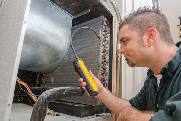 HVAC Technician with Leak Detector