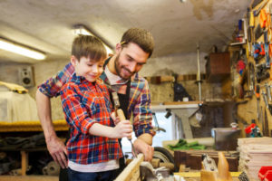 image of father and son working in the garage