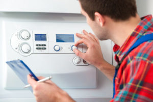 image of an hvac contractor repairing a boiler