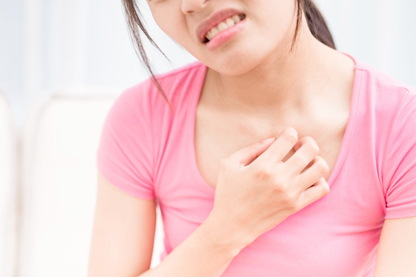 image of woman feeling itchy due to dry indoor air