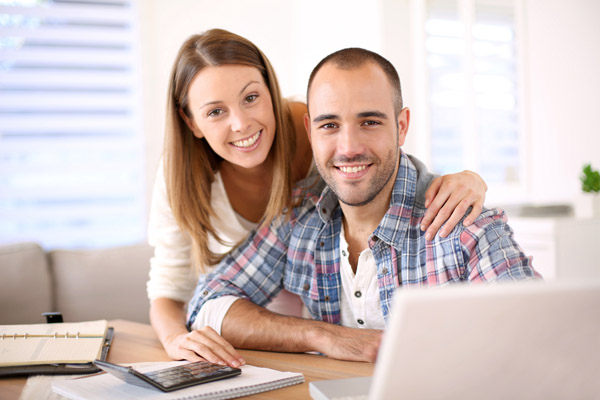 Smiling couple calculating energy savings