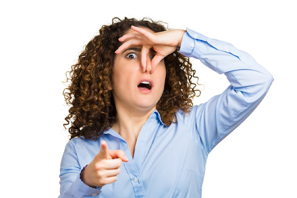 image of a homeowner plugging nose due to dead animal in ductwork