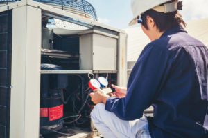 hvac technician is checking air conditioner during hvac installation