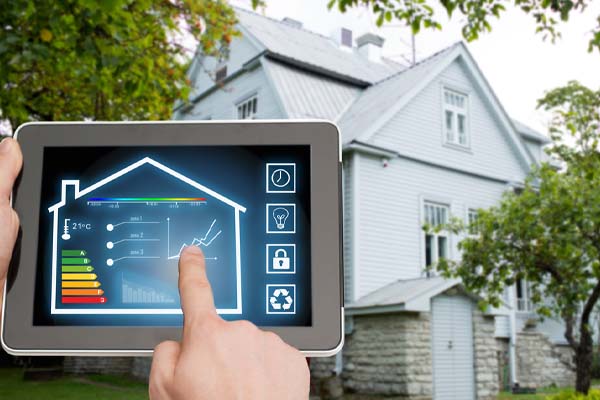 image of homeowner using phone to determine energy use and wi-fi thermostat