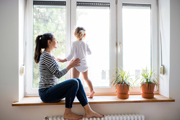 mother and daughter by radiator and hydronic heating system