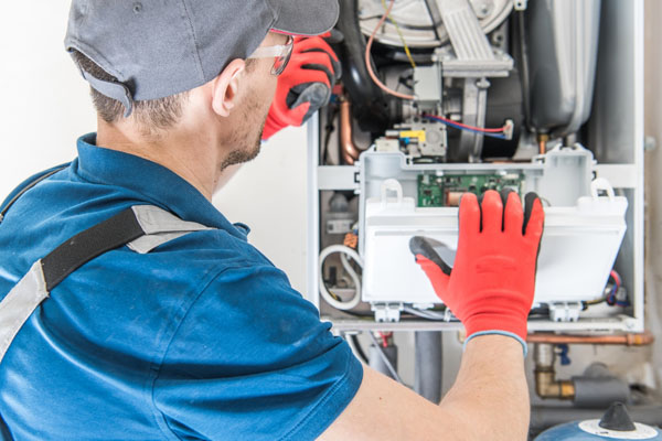 image of an hvac contractor performing a furnace tune-up