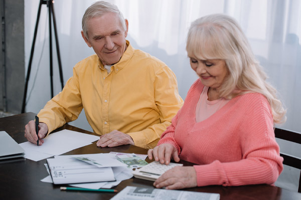 Smiling couple calculating home heating savings