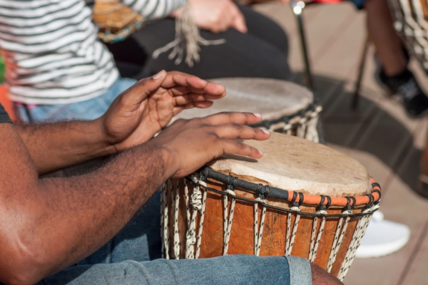 man hands pounding on African drum depicting thumping sounds from HVAC unit