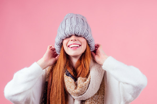 image of a homeowner bundling up with warm clothes due to a furnace not working