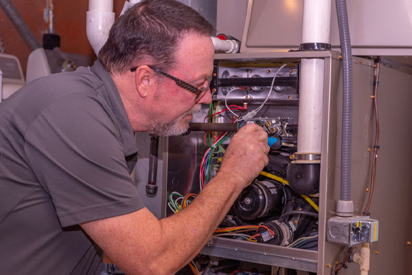 image of an gas furnace and hvac technician