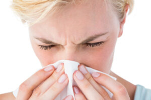 image of a homeowner experiencing allergies at home