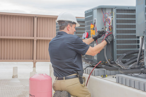 image of hvac contractor performing refrigerant refill on air conditioner