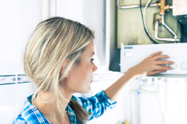 image of a homeowner inspecting their water boiler