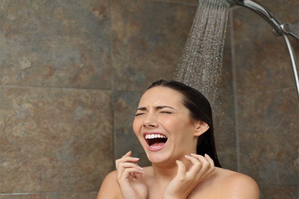 image of a homeowner taking a cold shower depicting boiler not producing cold water