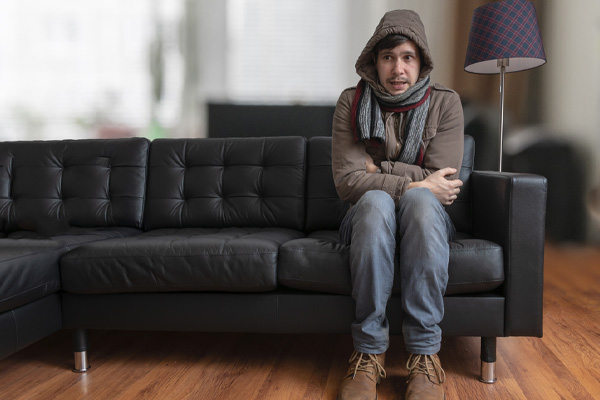 image of homeowner feeling chilly due to furnace breakdown