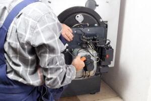 image of a boiler and an hvac contractor performing oil boiler maintenance