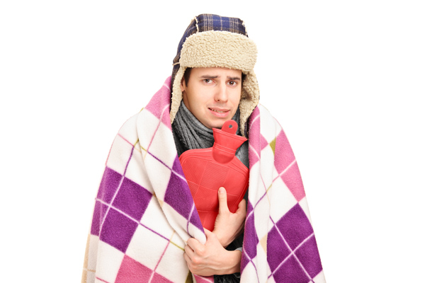 image of a homeowner feeling chilly due to furnace problems at home