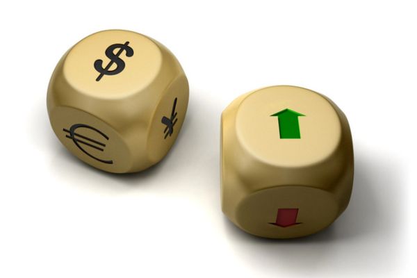 golden currency dice beside a golden dice with green arrow pointing up depicting currency fluctuation and inflation