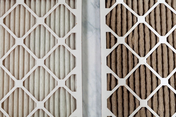 side by side close up view of new and old HVAC air filters