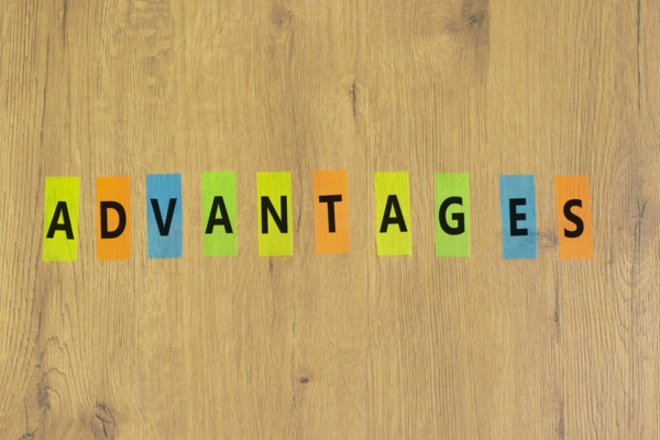 ADVANTAGES spelled using letters written on colored papers depicting Heating Oil and Hot Water Radiators