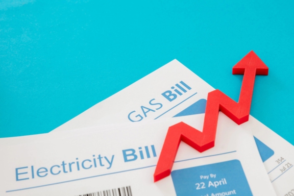 Electricity and gas bills with rising arrow