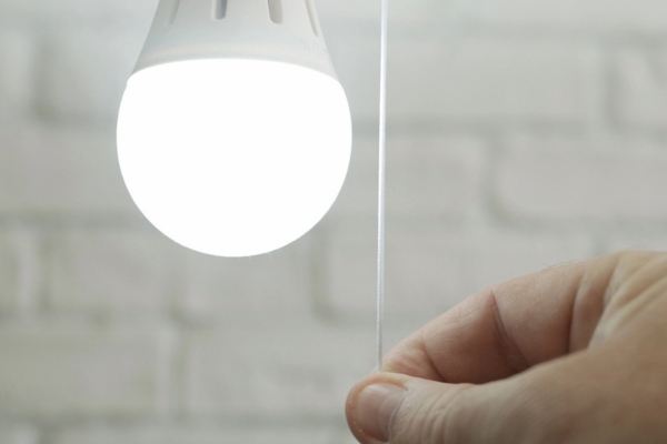 man's hand turning on LED light