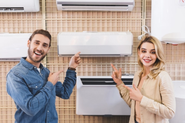 couple showing new air conditioner at an appliance aisle while shopping