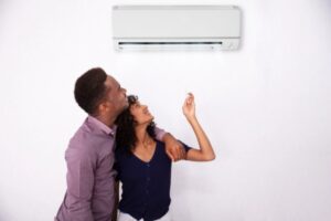 couple turning on new AC at home