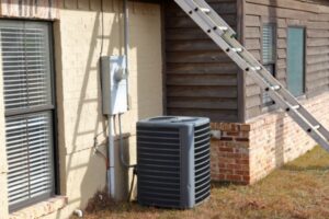 gray air conditioner unit installed outside a house