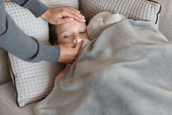 mother wiping daughter's nose depicting air conditioner sickness